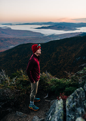 man night hiking wearing midweight merino wool quarter zip