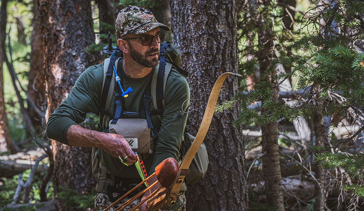 Man archery hunting wearing minus33 merino wool base layer top