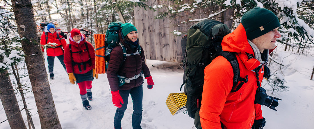 group of people winter hiking wearing merino wool beanies 