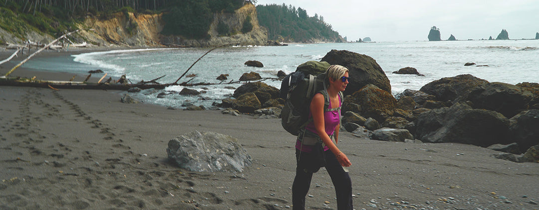 woman walking the beach wearing merino wool tank top