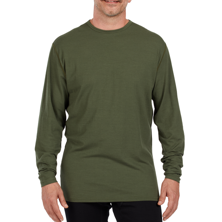 A man models the microweight long sleeved merino wool base layer crew neck top 