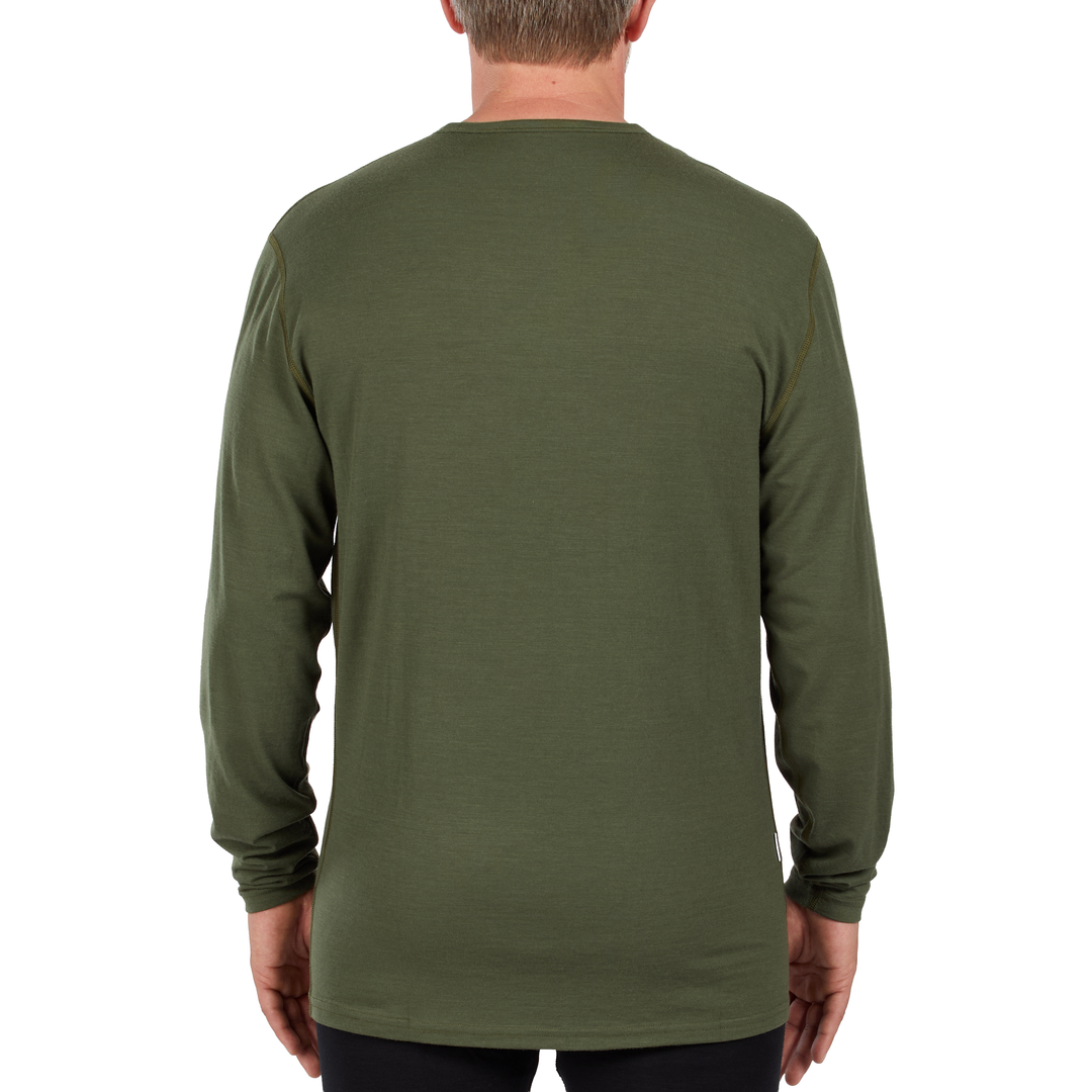 A man models the microweight long sleeved merino wool base layer crew neck top 