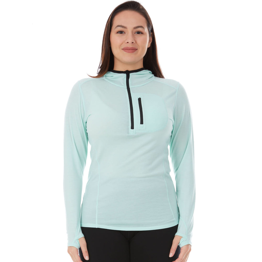 Woman wears a microweight Merino wool sun hoodie  #color_mint