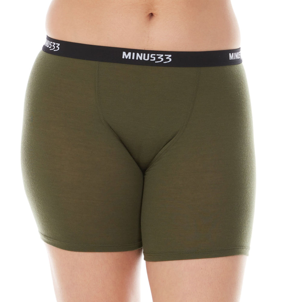 A woman models the microweight merino wool women's boxer briefs. The boxer briefs have a five inch inseam and a one inch woven sport elastic waistband #color_olive-drab-green