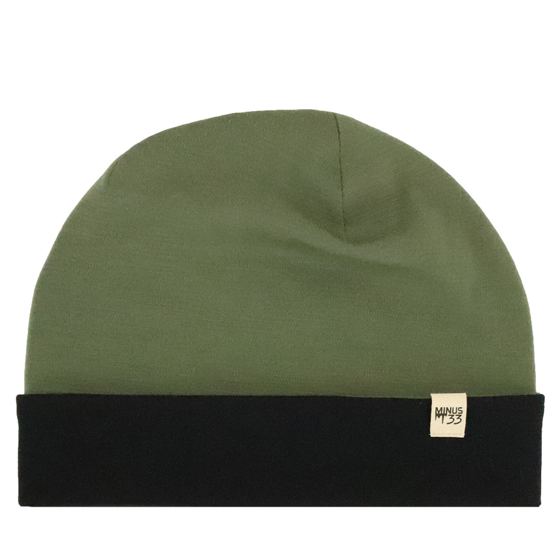 An olive green beanie hat with a black folded cuff and a small beige brand tag on the side, shown against a plain white background. 