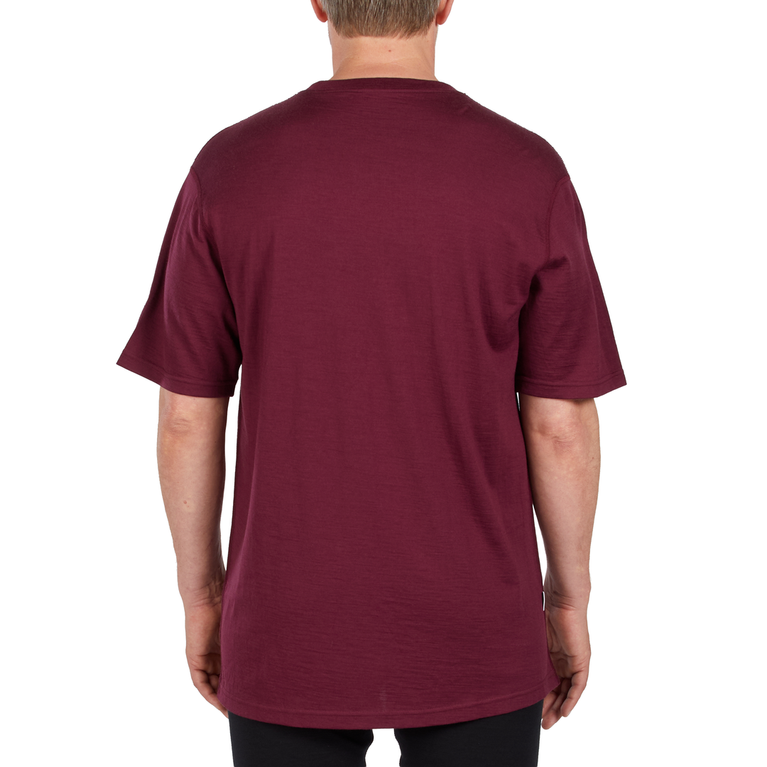 A man models a super soft, short sleeved merino wool t shirt. Use it as a base layer under your work shirt, or wear it all by itself during your next summer summit. 