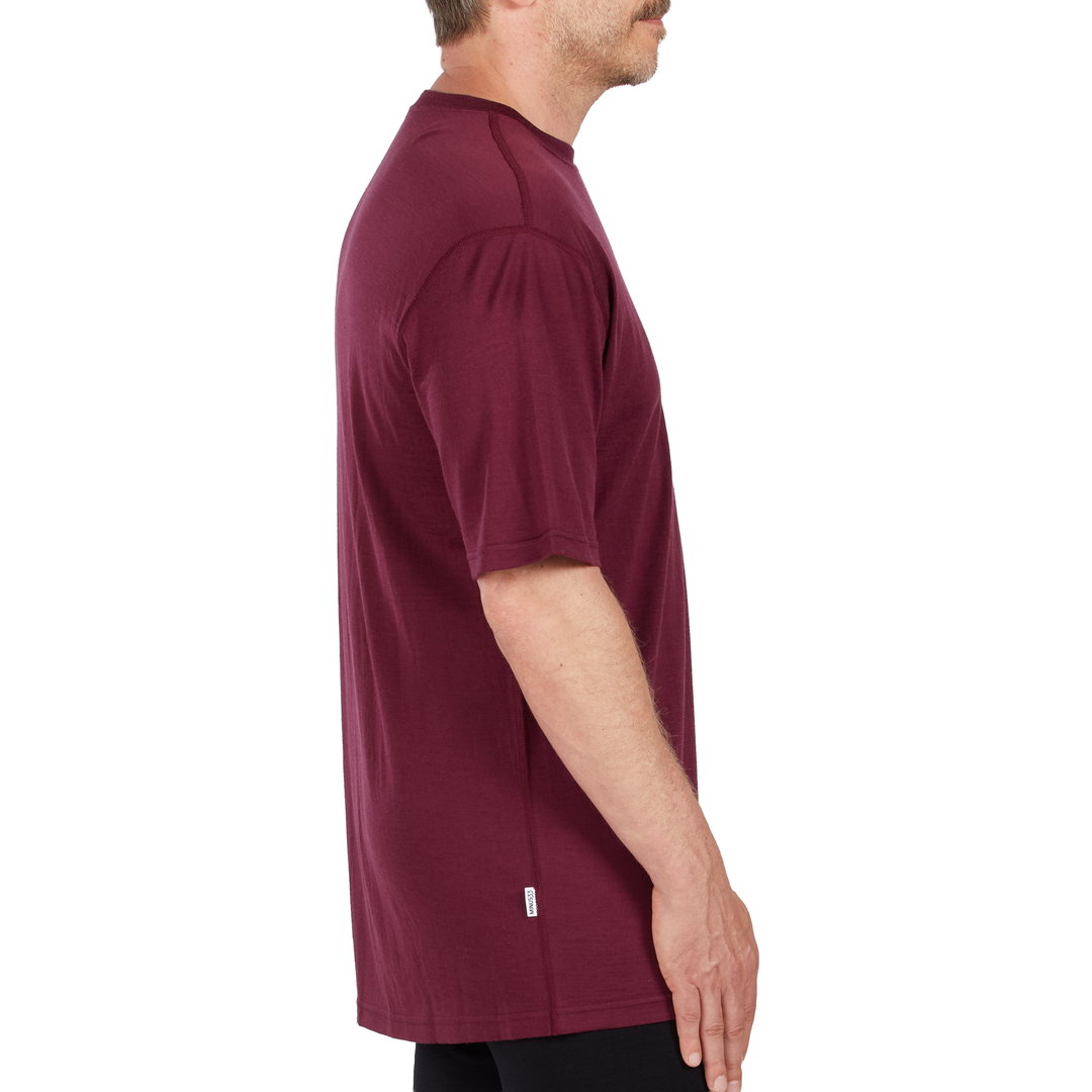 A man models a super soft, short sleeved merino wool t shirt. Use it as a base layer under your work shirt, or wear it all by itself during your next summer summit. 