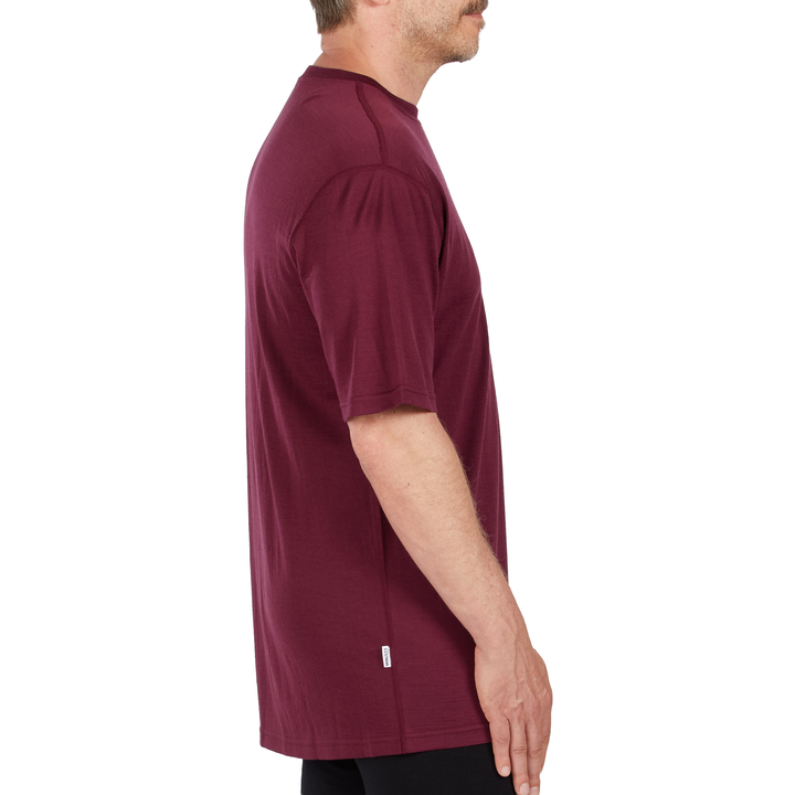 A man models a super soft, short sleeved merino wool t shirt. Use it as a base layer under your work shirt, or wear it all by itself during your next summer summit. 