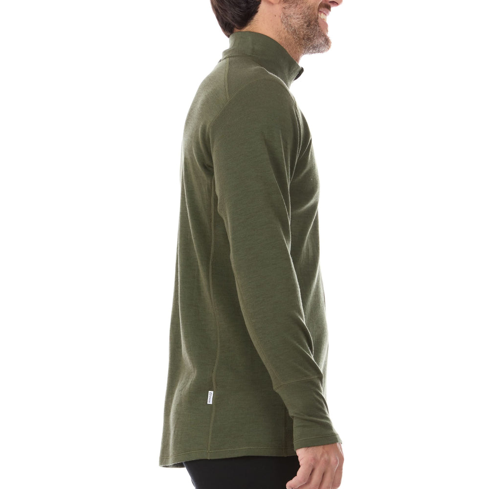 A man models the merino wool midweight quarter zip sweater, complete with flat-lock seams and thumbholes. #color_olive-drab-green