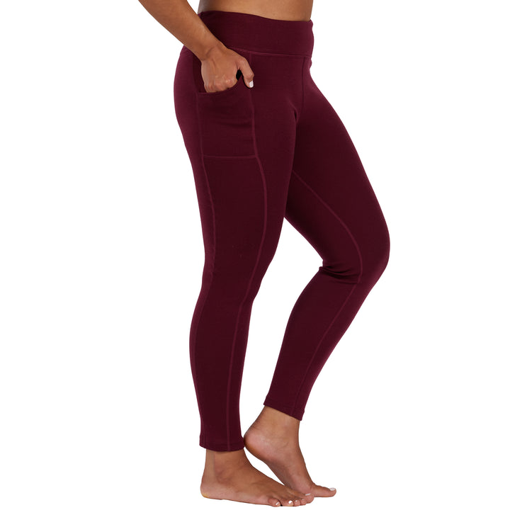 womens burgundy expedition weight leggings side profile with the models hand in their pocket 
