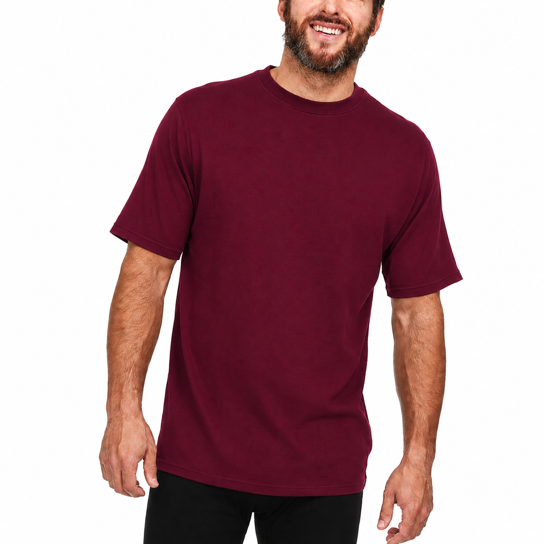 A man models a super soft, short sleeved merino wool t shirt. Use it as a base layer under your work shirt, or wear it all by itself during your next summer summit. 