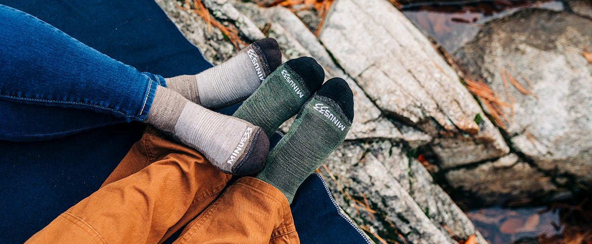 new hampshire usa made socks peole sitting on a blanket on rocks wearing mountain heritage socks