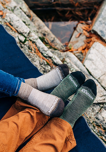 new hampshire usa made socks peole sitting on a blanket on rocks wearing mountain heritage socks