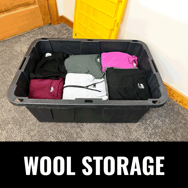 Wool clothing folded and saved in a large black and yellow tote